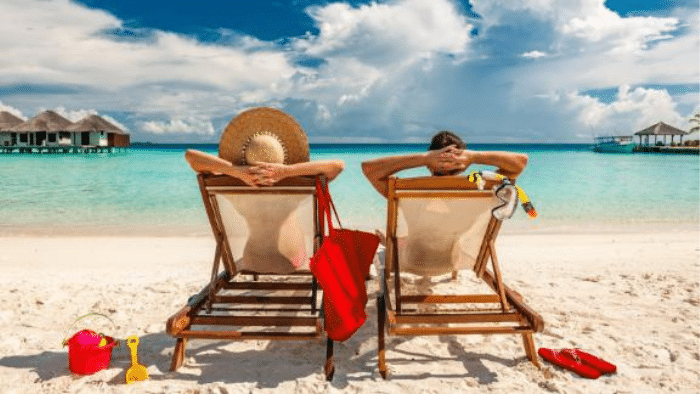 5 Reasons You Should Be Planning (and Even Booking) Your Travel Now | Enlightened Journeys Travel a couple in bathing suits in a luxury resort on the beach